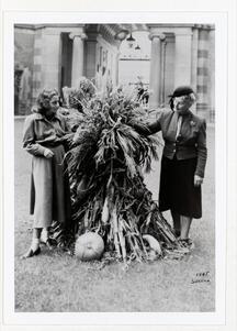 A younger woman and Adele Ginzberg holding a large bunch of reeds