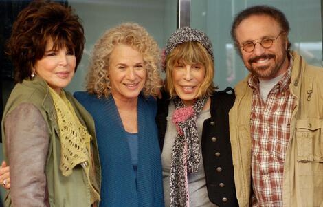 Carole Bayer Sager, Carole King, Cynthia Wil, and Barry Man standing together with their arms around each other