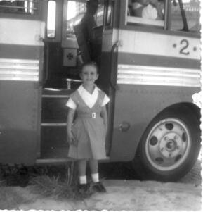 Ruth Behar as a child, standing in the open door of a bus