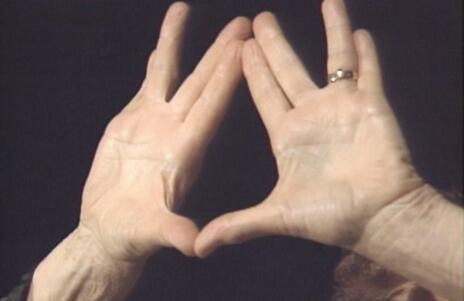 Close up of Anna Halprin's hands in the shape of the priestly blessing