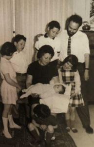 Alice Shalvi and her famil - woman holding baby and surrounded by 5 other children and her husband