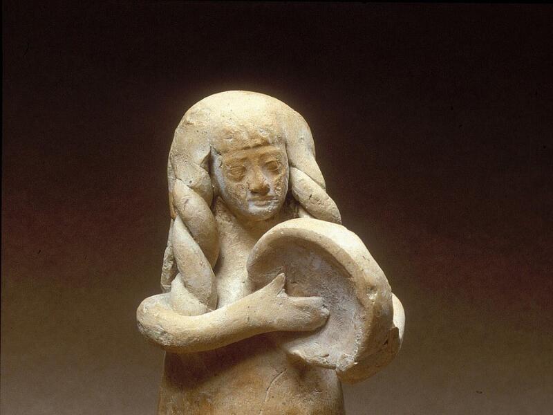 Figurine of woman playing drum