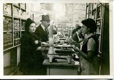 Anne Russ helping customers at the counter