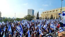Large group of people holding Israeli flags at a protest
