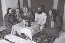 A Yemenite family gathered around the table during Shabbat, 1947.