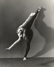 Cecilia Baram posing with one leg lifted back above her head and her arms extended