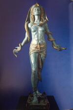 Patinated bronze statue 42 inches tall of Egyptian goddess with snake wrapped around arms