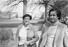 Jean Sammet and Michael Brodie from waist up, walking and smiling outside on the University of Maryland