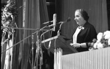 Golda Meir speaks at a podium at the 50th anniversary celebration of the Histadrut