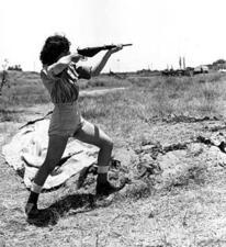 A female Haganah officer demonstrates how to fire a STEN gun, 1948 