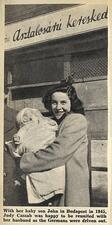 Newspaper picture of Judy Cassab holding a baby