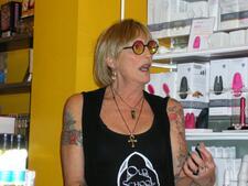 Kate Bornstein wearing a black tank top and sunglasses at Babeland in Seattle
