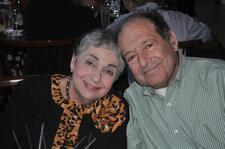 Meyera Oberndorf, left, and her husband Roger, right, posed smiling for photo at a restaurant