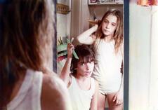 Two children shown in a mirror combing their hair in Boy Meets Girl