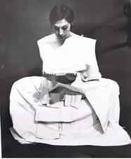 Ruth Eshel posing, draped with squares of white fabric