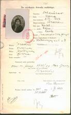 A form, printed in Polish with handwritten responses. A small black and white photo is in the upper lefthand corner and there is a red stamp.