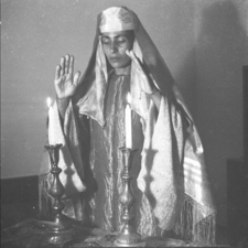 Yemenite ballerina Rachel Nadav lighting Shabbat candles, 1945. Photo by Zoltan Kruger via Israel State Archives.