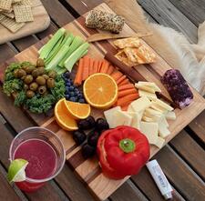 A charcuterie board with cheese and fruit