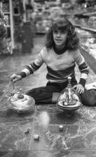 A child playing with dreidels around Hanukkah, 1979.