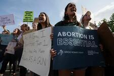 Abortion rights demonstrators hold signs outside US Supreme Court after leaked SCOTUS opinion.  