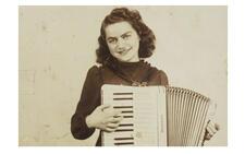 A young Flory Jagoda holding an accordion