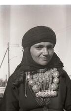 A woman wears jewelry handmade by a goldsmith in Hatzermat, Yemen. 1964. 