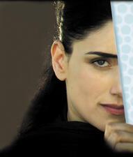 A portrait of Ronit Elkabetz with half her face obscured