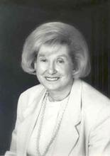 Headshot of Florence Levin Denmark wearing a blazer and smiling to the camera