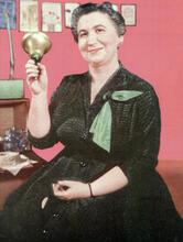 Frances Horwich, holding up a bell