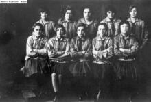 Two rows of young women in uniforms