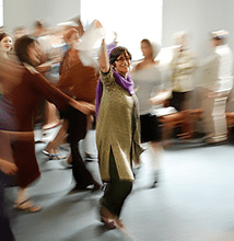Judith Brin Ingber in focus leading dance at a Minnesota bat mitzvah party reception, others in motion around her