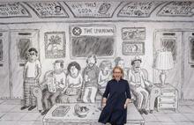New Yorker cartoonist, Roz Chast stands in front of mural