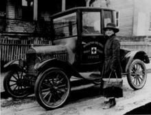 A Red Cross Public Health Nurse with her Model T Ford