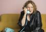 Comedian Judy Gold talking on a rotary phone