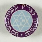 A circular badge with a white star of David and the letters "JLWS" on a pale blue field in the center, and Hebrew writing around a purple edge