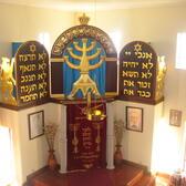 Interior of synagogue in Belmonte, showing bimah and the traditional rezadeiras oil lamp