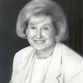 Headshot of Florence Levin Denmark wearing a blazer and smiling to the camera