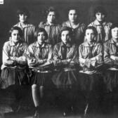 Two rows of young women in uniforms