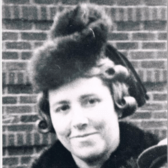 Irma Rothschild Jung in front of a brick wall, wearing a fur hat and coat