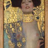 Oil painting by Gustav Klimt depicting a semi-nude Judith prominently, holding the head of Holofernes in the bottom right 