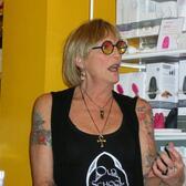 Kate Bornstein wearing a black tank top and sunglasses at Babeland in Seattle