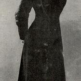 Lily Kronberger wearing ice skates, a long dress, and a hat