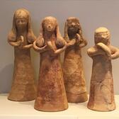 Four 6-8 inch tall terracotta figurines of women holding hand drums