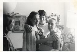 Cecilia Baram meeting Anna Sokolow, with another woman standing in the corner and a young man putting his arms around both dancers