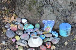 Decorated stones and sentimental items gathered in memory of Michael