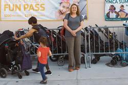 Therese Shechter stands in front of a bunch of strollers in My So-Called Selfish Life