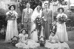 Outdoor portrait of a married couple and five members of the wedding party