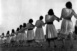 Row of women dancing with backs to camera
