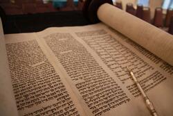 Open Torah scroll with yad.
