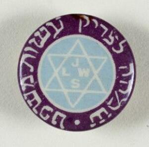 A circular badge with a white star of David and the letters "JLWS" on a pale blue field in the center, and Hebrew writing around a purple edge